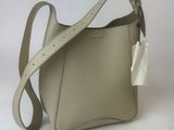 a white purse with a white bow on the handle