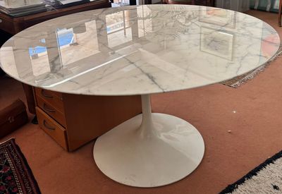 une table en marbre avec un plateau en verre dans un salon