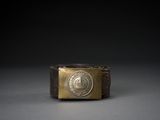 a close up of a gold ring with a coin on it