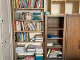 a bookshelf full of books in the corner of a room