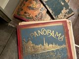 an old book sitting on the floor next to a pile of books