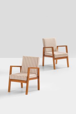 three wooden chairs with striped upholstered cushions in a white room