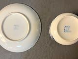two white plates with blue designs on them on a table