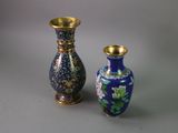 two vases sitting next to each other on a table