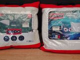 two pillows that are sitting on top of a table