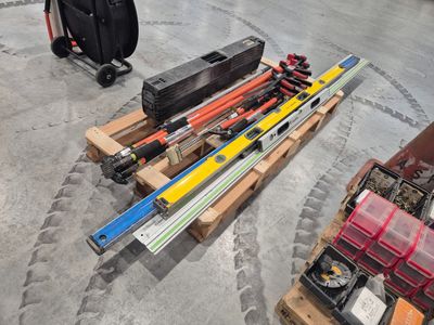 many different types of skis and ski poles on a pallet