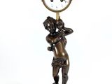 a statue of a man holding a clock on a pedestal