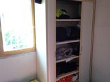 a closet with a lot of clothes in it