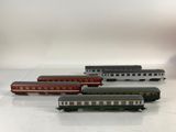 several toy trains are lined up on a white surface