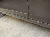 a close up of a car ' s side door with a flat tire