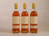 three bottles of wine sitting next to each other on a white surface