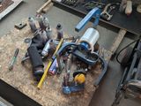 a lot of tools that are sitting on a workbench