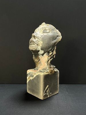 an image of a sculpture of a head on top of a block