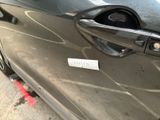 a close up of a car door handle with a sticker on it