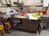a workbench with a bunch of tools on top of it