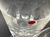 a wine glass with a red spot in it
