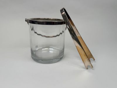 a glass jar with a wooden lid on a white surface