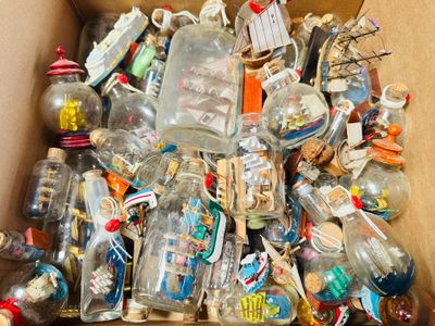 a cardboard box full of glass bottles and other items