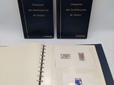 two books on a white table with a black cover and a blue cover