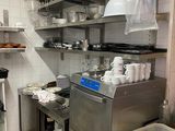 a kitchen with a lot of pots and pans on the shelves