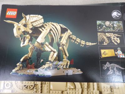 a box of legos with a picture of a t - rex on it