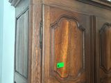 a wooden armoire with a mirror on top of it