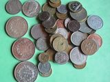 a pile of coins sitting on a green surface
