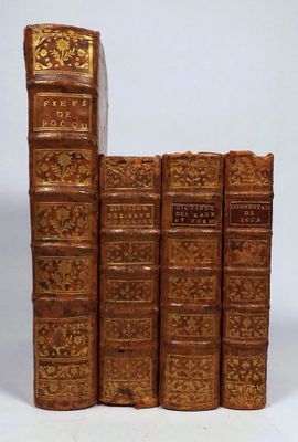 three books are stacked on top of each other on a white surface