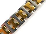 a close up of a gold and silver bracelet on a white surface