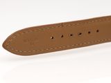 a close up of a brown leather belt on a white surface