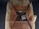 a brown bag with a gun in it on a table