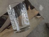 a glass with a coca cola logo on it