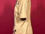 an image of a mannequin wearing a tan coat on a mannequin stand