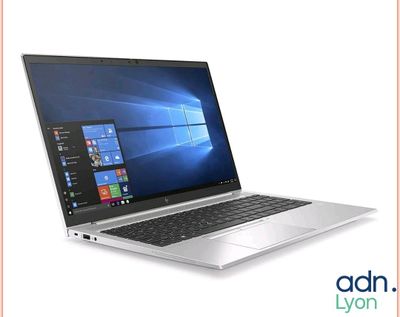 an open laptop computer sitting on top of a white surface