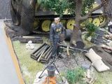 a model of a man standing in front of a tank