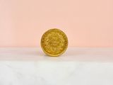 a gold coin sitting on top of a marble slab