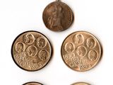 four british coins are arranged in a row on a white surface