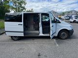 a white van parked in a parking lot with its doors open
