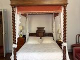 a bed with a canopy in the middle of a room
