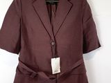 brown blazer jacket on a hanger on a white wall