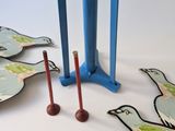 four birds that are standing next to each other on a table