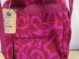 pink leopard print handbag with a brown strap and a tag on it