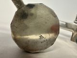 a silver spoon sitting on top of a white table