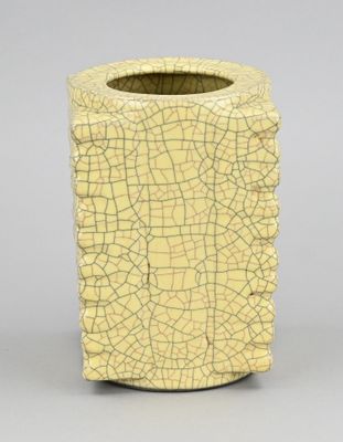 un vase jaune dont la surface est craquelée