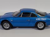 a blue toy car that is sitting on a white surface