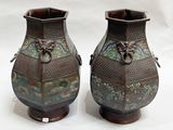 two vases that are sitting on a white surface