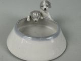 two dogs sitting in a bowl on a table
