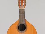 a guitar hanging from a string on a wall