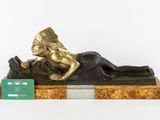 statue of a woman laying down on a marble base with a credit card in her hand