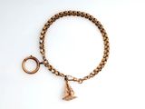 a close up of a bracelet with a gold charm on it